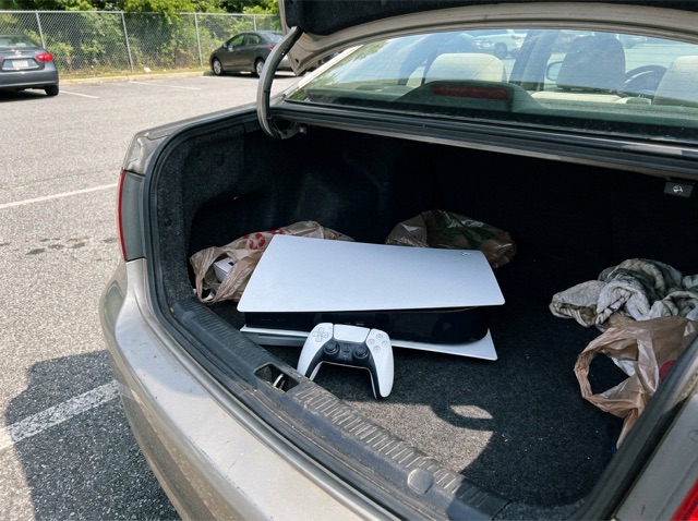 Game console in a car trunk